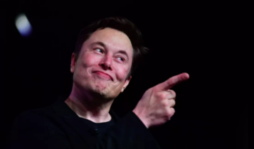 Elon Musk sorri e aponta dedo ao horizonte