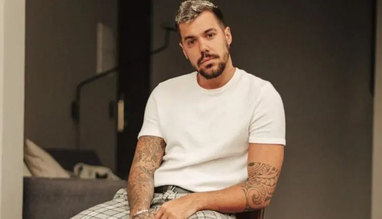 Lipe Ribeiro sentado olhando para frente