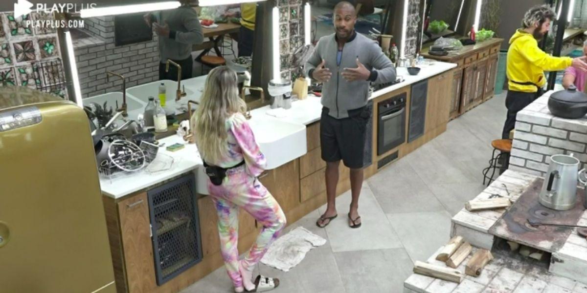Carol Narizinho na cozinha conversando em pé com Rodrigo Moraes em "A Fazenda 2020"