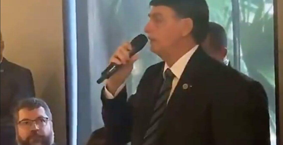 Imagem mostra Bolsonaro segurando um microfone durante uma reunião com seus apoiadores