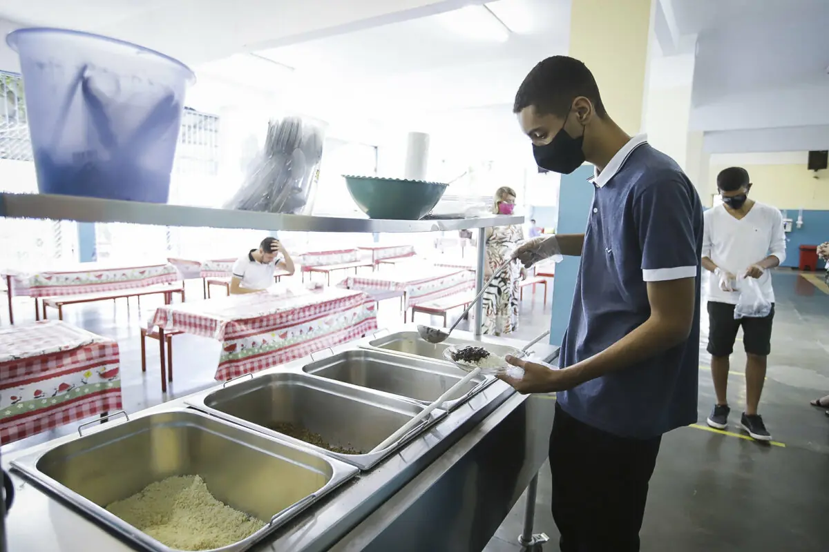 Aluno pegando merenda escolar