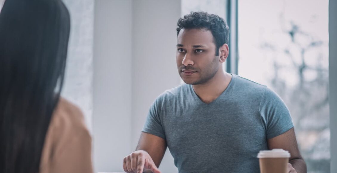 Foto mostra trabalhadora e empregador conversando sobre pedido de demissão